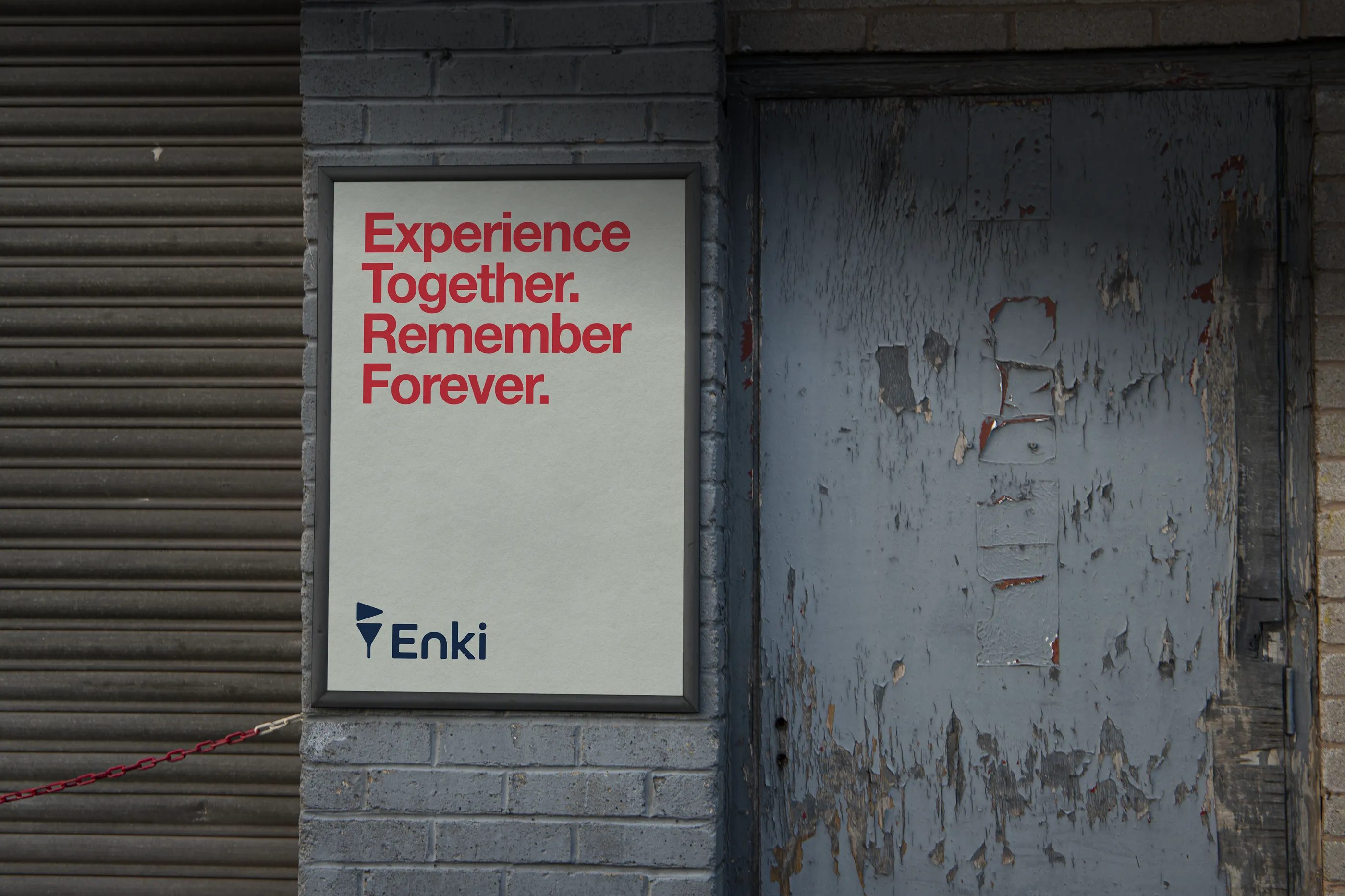 Enki street poster on a brick wall: Experience Together. Remember Forever.